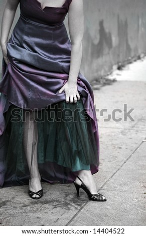 A colorized image of a woman wearing an evening gown in the city