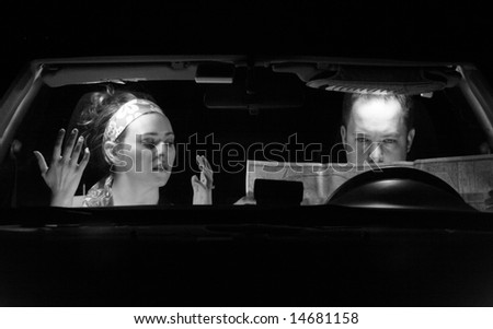 A couple in the car look at a map