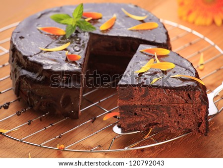 Homemade sacher (chocolate cake with jam) cake with petal