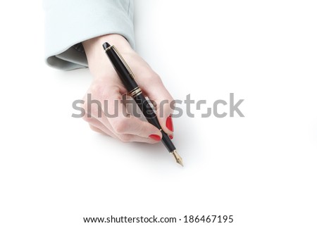 Close-up of businesswoman\'s hand writing with fountain pen on white paper.