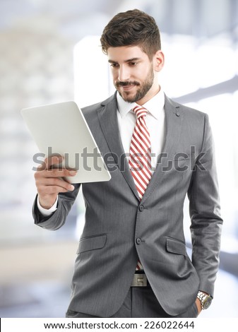 Portrait of executive businessman holding digital tablet.