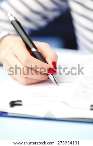 Close-up portrait of financial administrator sitting at office while signing the contract.