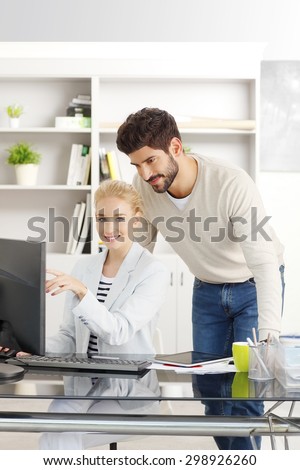 Portrait of young financial business people sitting in front of computer and using private banking. Bank employees working online.