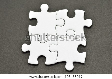 Plain white jigsaw puzzle, on Black background.