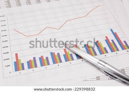 Business performance analysis. Business Graphs and pen.