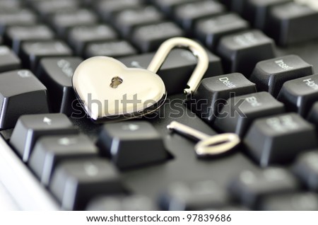 Computer security. Close-up of Heart-shaped padlock on keyboard.