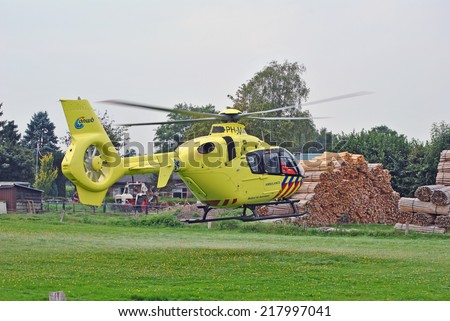 ELSPEET, THE NETHERLANDS, 5 september 2014 - Dutch ambulance helicopter in a pasture.