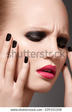 Beautiful close-up portrait of fashion woman model with glamour bright makeup, dark magenta lipstick, black nail polish. Evening catwalk style, trend visage and manicure