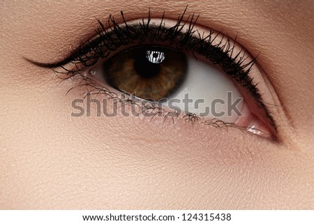 Cosmetics & make-up. Beautiful female eye with black liner makeup