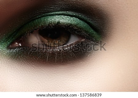 Elegance close-up of female eye with mint color eyeshadow. Macro shot of beautiful woman\'s face part. Wellness, cosmetics and make-up.