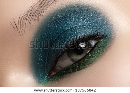 Elegance close-up of female eye with celadon color eyeshadow. Macro shot of beautiful woman\'s face part. Wellness, cosmetics and make-up.