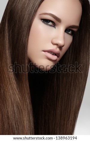 Health, beauty, wellness, haircare, cosmetics and make-up. Beautiful fashion hairstyle. Woman model with glossy straight long hair and evening make-up.