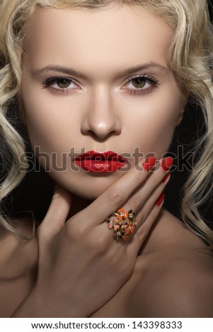 Wellness, cosmetics and romantic retro style. Close-up portrait of sensuality beautiful blond woman model face with fashion make-up, sexy evening red lips makeup and bright red manicure