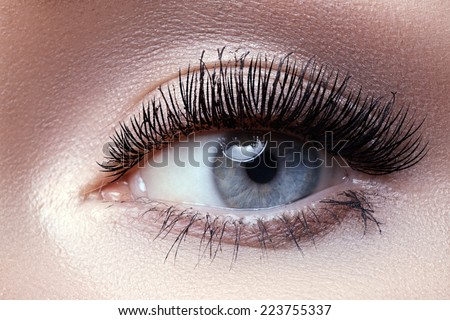 Macro shot of woman\'s beautiful eye with extremely long eyelashes. Sexy view, sensual look
