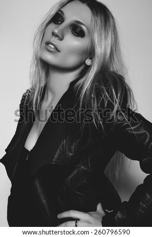 Beautiful portrait of rock woman model in leather jacket with dark evening make-up. Perfect street fashion. Punk clothes with spikes