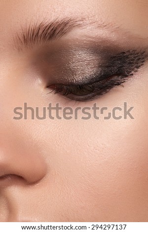 Cosmetics & make-up. Beautiful female eye with sexy black liner and bright makeup. Chic evening make-up