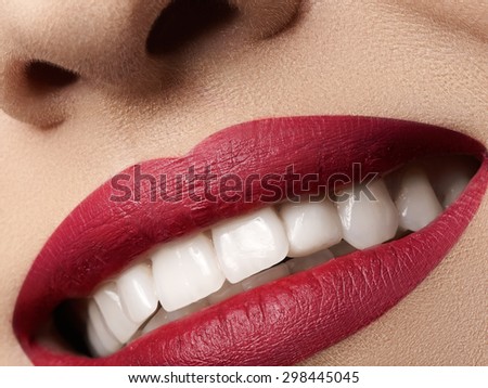 Close-up happy female smile with healthy white teeth, bright magenta lips make-up. Cosmetology, dentistry and beauty care. Macro of woman\'s smiling mouth. Beautiful smile