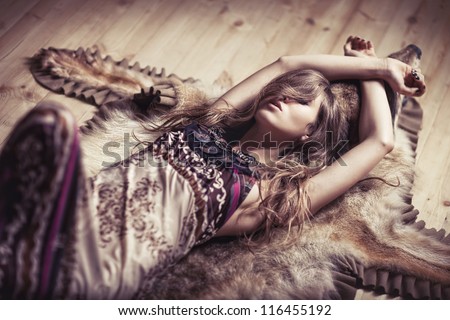 Girl laying on a skin of the wolf