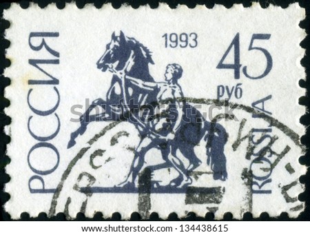 RUSSIA - CIRCA 1992: A stamp printed in Russia shows Sculpture rider leading the horse by the bridle on Anichkov Bridge in St Petersburg, circa 1992