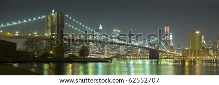 Panoramic view of the Brooklyn Bridge and New York skyline at night from Brooklyn.