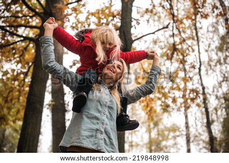 Mother with daughter in autumn park