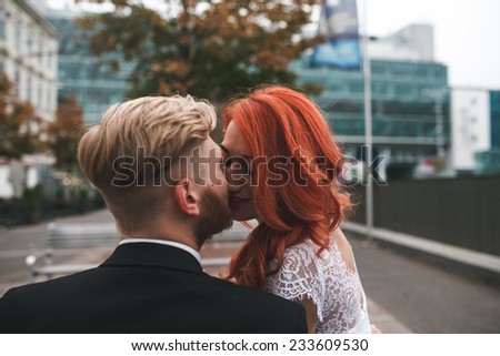 Wedding couple sitting on a bench in a futuristic building
