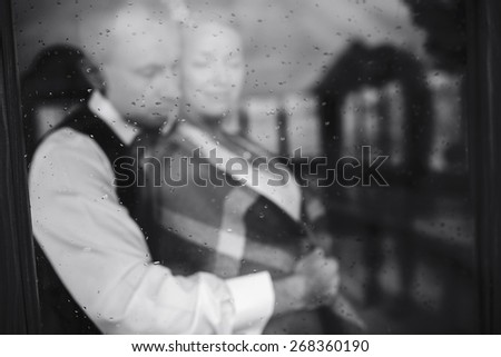 Wedding couple together close to each other at the window