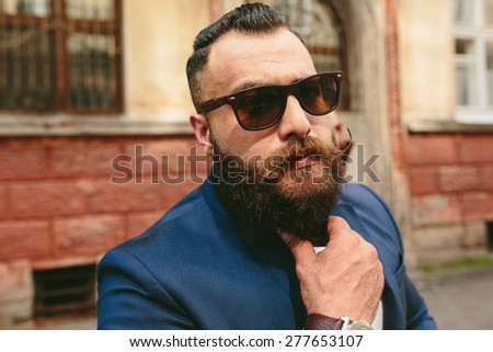 stylish bearded man on the background of the old town
