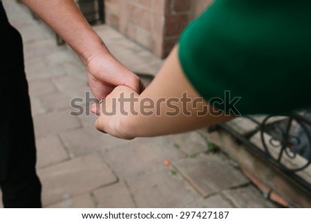 close picture of a beautiful couple where the guy takes the girl's hand
