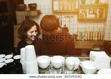 Vintage couple preparing coffee with vacuum coffee maker.Coffee shop.  Vintage toned