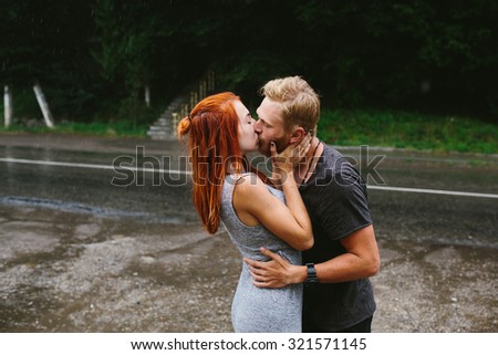 man throws up his girlfriend in the rain