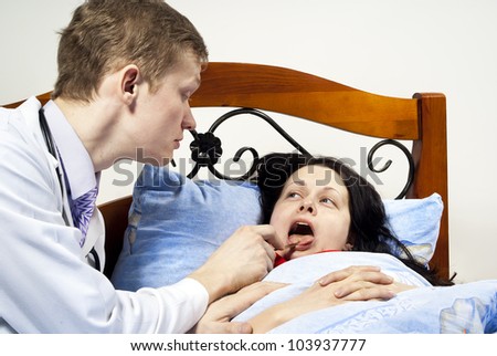 doctor treats the patient\'s throat at his home
