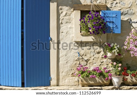 Cottage, house with blue door, shutter, flower. Provence. France.