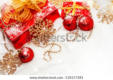 composition - Red and gold Christmas gifts and decorations on a white snow