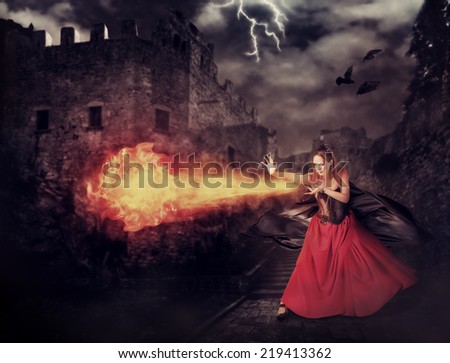 beautiful woman witch trains in medieval castle cast magic - fireball
