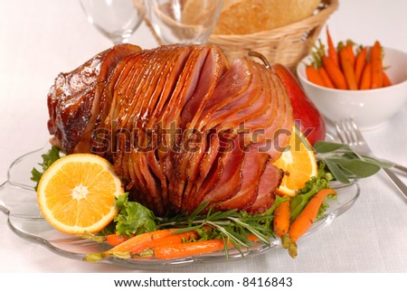 Brown sugar and honey glazed ham with carrots, herbs, fruit and bread