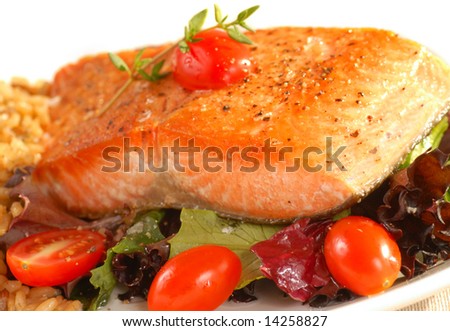 Fresh seared salmon resting on a micro green salad with brown rice