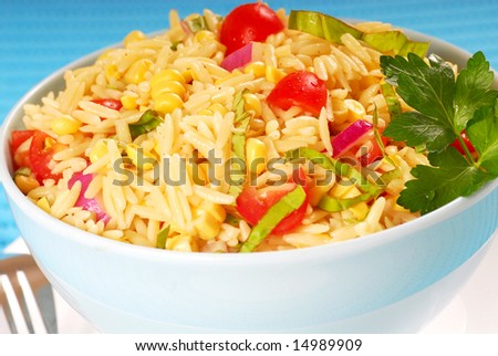 Bowl of healthy orzo pasta salad in a white bowl