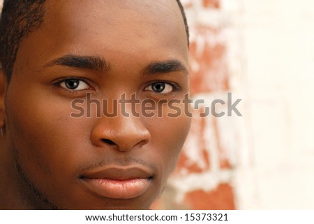 Closeup of the face of an African American male with a faint smile