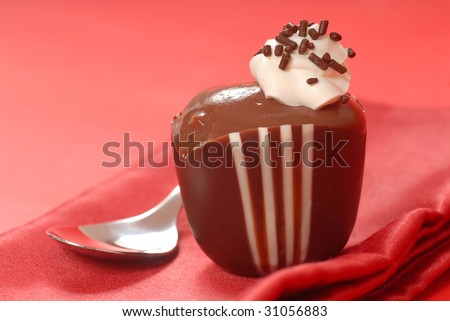 Freshly made chocolate pudding in a dark and white chocolate cup
