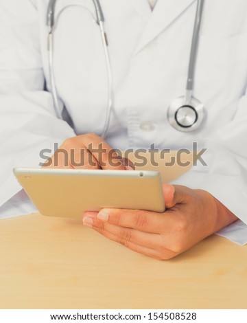 Close up of an Asian female doctor diagnoses by using tablet.