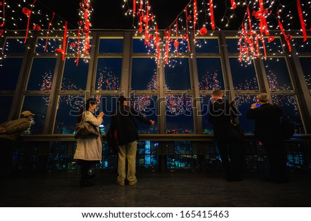 TOKYO, JAPAN - NOVEMBER 25: Tokyo Tower in Tokyo, Japan on November 25, 2013. Unidentified people looks at the Tokyo city from the main observatory deck in Tokyo Tower which prepare for the Christmas