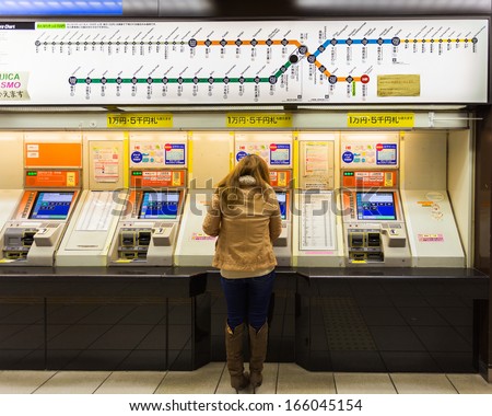 FUKUOKA, JAPAN - NOVEMBER 13: Buying train ticket in Fukuoka, Japan on November 13, 2013. Unidentified female buy train tickets from vending machine at Fukuoka international airport