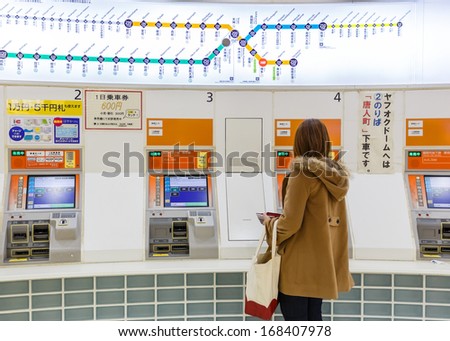 FUKUOKA, JAPAN - NOVEMBER 14: Buying train ticket in Fukuoka, Japan on November 14, 2013. Unidentified people buy tickets from vending machine at Hakata Station