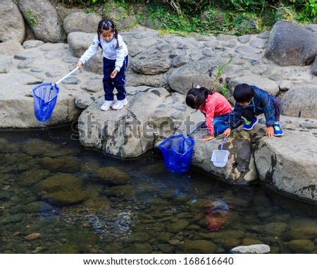 NAGASAKI, JAPAN - NOVEMBER 14: Nakashima River in Nagasaki, Japan on November 14, 2013. Teachers take students to collect garbage from the river as an activity for environmental learning process