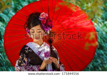 OKAYAMA, JAPAN - NOVEMBER 17: Japanese woman in Okayama, Japan on November 17, 2013. Unidentified female dresses Kimono for her wedding ceremony at Koraku-en garden