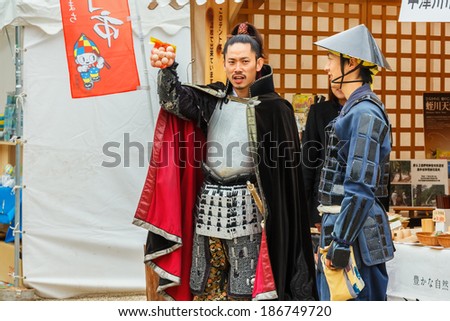 NAGOYA, JAPAN - NOVEMBER 21: Japanese Fair in Nagoya, Japan on November 21, 2013. Japanese vendors dress old style warrior costume to promote his product at Nagoya Castle Fair