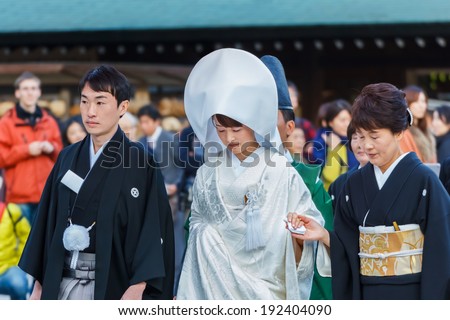 TOKYO, JAPAN - NOVEMBER 23: Wedding Ceremony in Tokyo, Japan on November 23, 2013. Unidentified groom and bride attend a traditional wedding ceremony at Meiji shrine