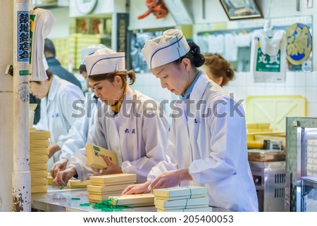 TOKYO, JAPAN - NOVEMBER 25: Tsukiji fish market in Tokyo, Japan on November 25, 2013. Unidentified japanese workers pack the food before distributing to customer