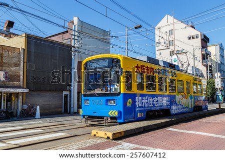 OSAKA, JAPAN - OCTOBER 24: Hankai Tram in Osaka, Japan on October 24, 2014. The Hankai Tramway in Osaka is affectionately known as the chin chin densha (ding ding train).